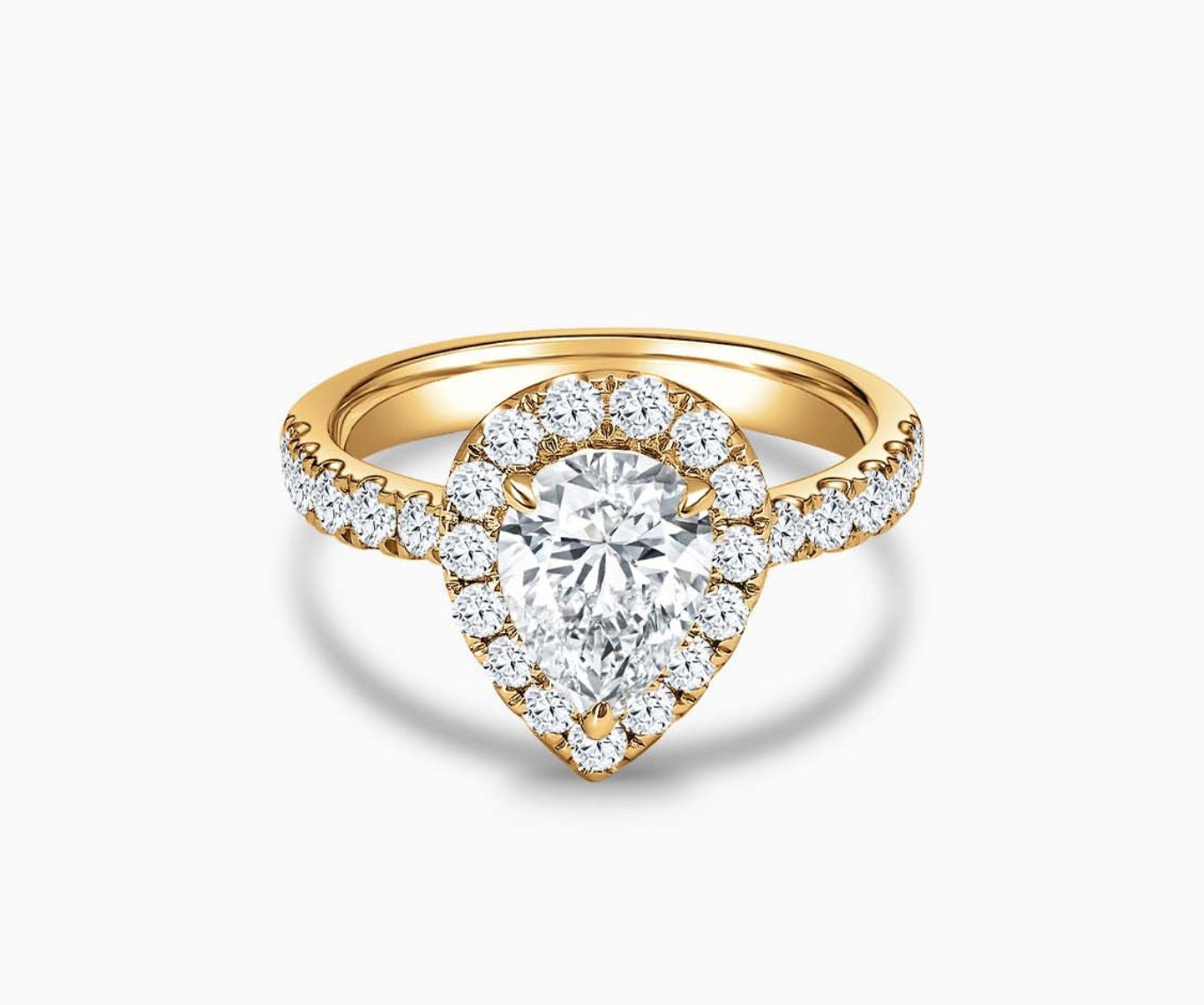 Pear Shaped diamond halo engagement ring set on yellow gold with a tapered pave band design