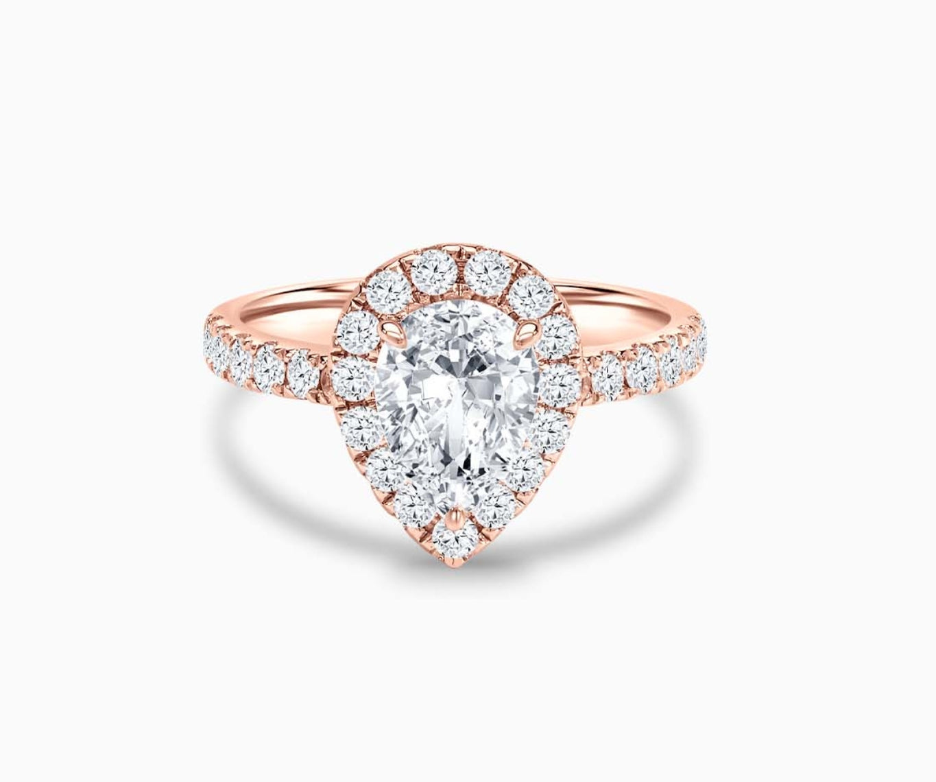 pear shaped diamond halo engagement ring set in rose gold with a straight pave band design