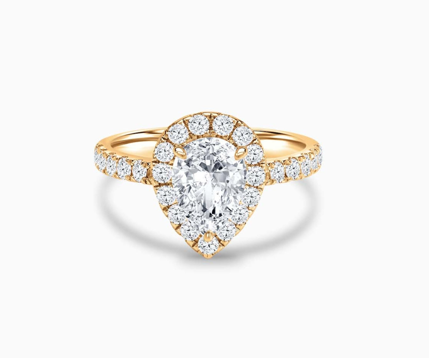 Pear Shaped diamond halo engagement ring set on yellow gold with a straight pave band design