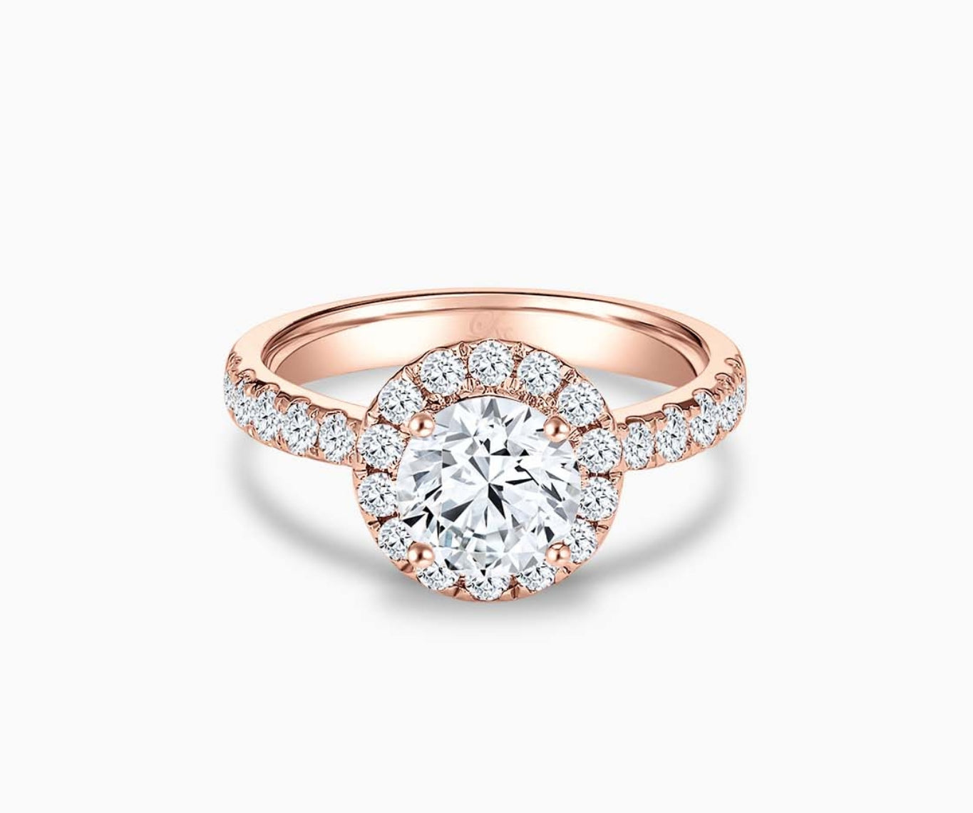 round diamond halo engagement ring set in rose gold with a tapered pave band design