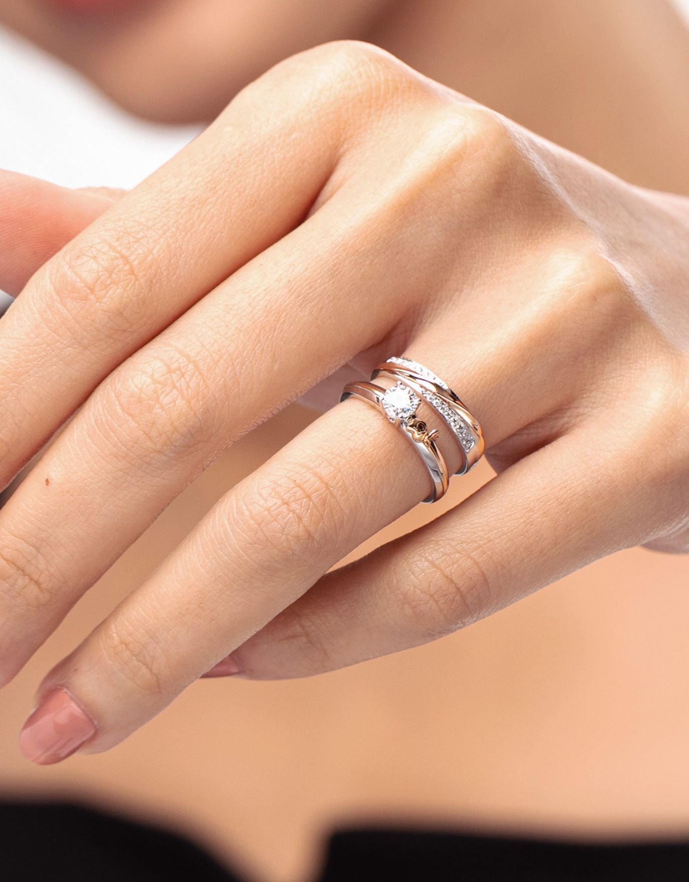 LVC wedding ring with two rows of diamond on a white gold and rose gold band stacked with an engagement ring