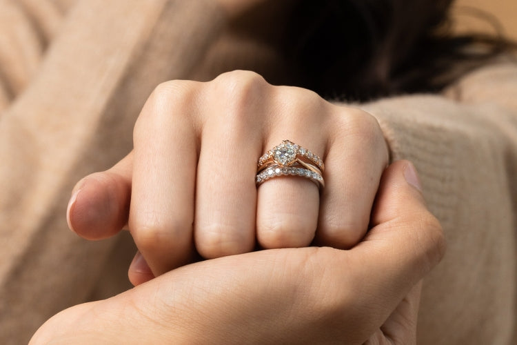 stacked rose gold solitaire diamond engagement ring with a matching wedding band