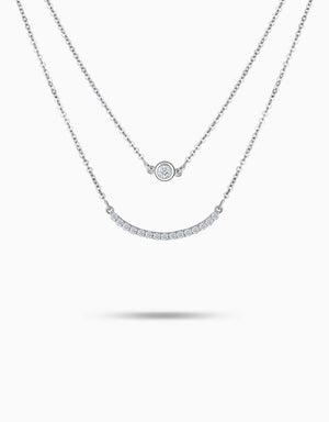 LVC necklace in white gold  features a delicate curve of pave round diamonds and a circlet pendant