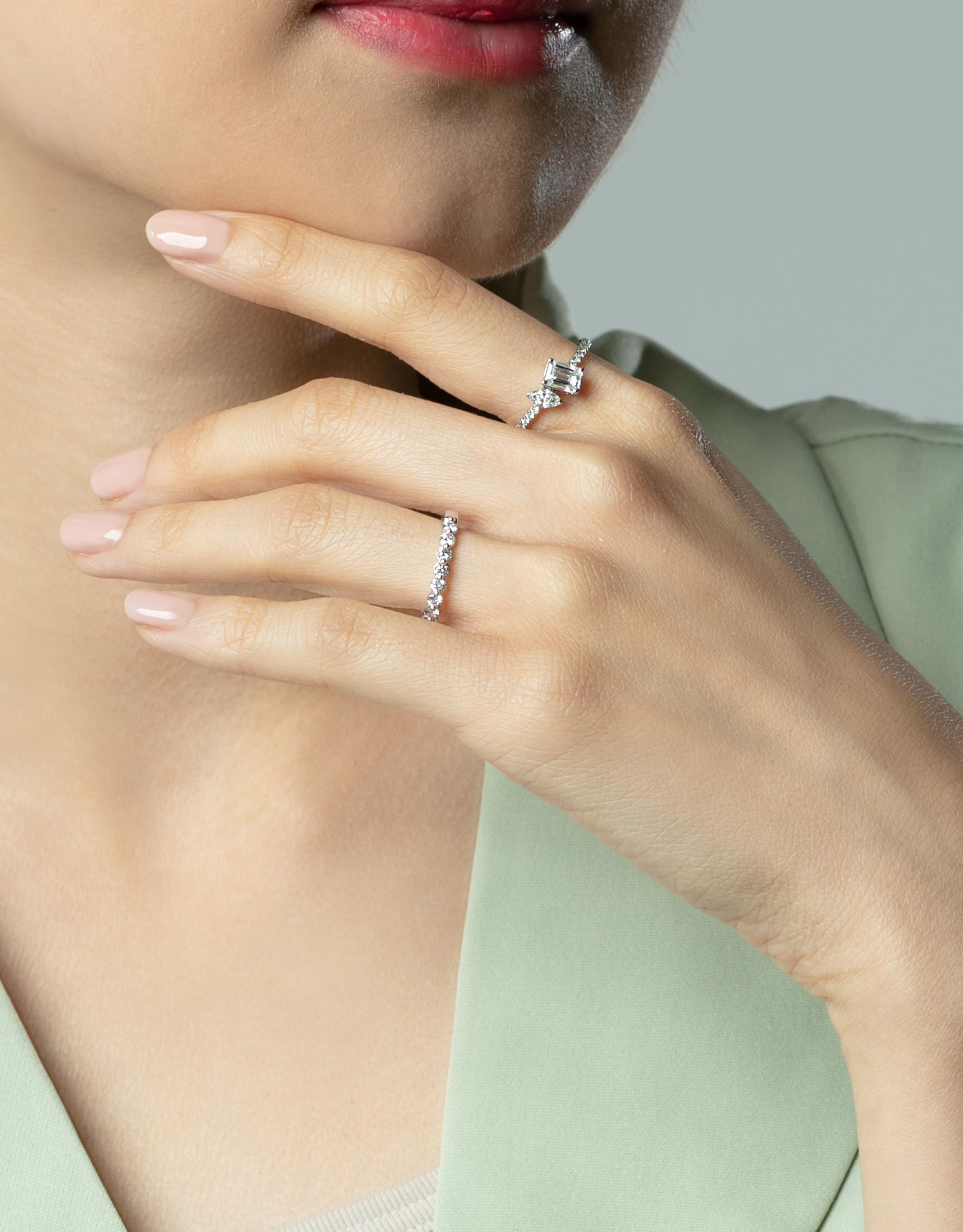 LVC a woman wearing the lab grown diamond ring with two center stones  in white gold on her index finger