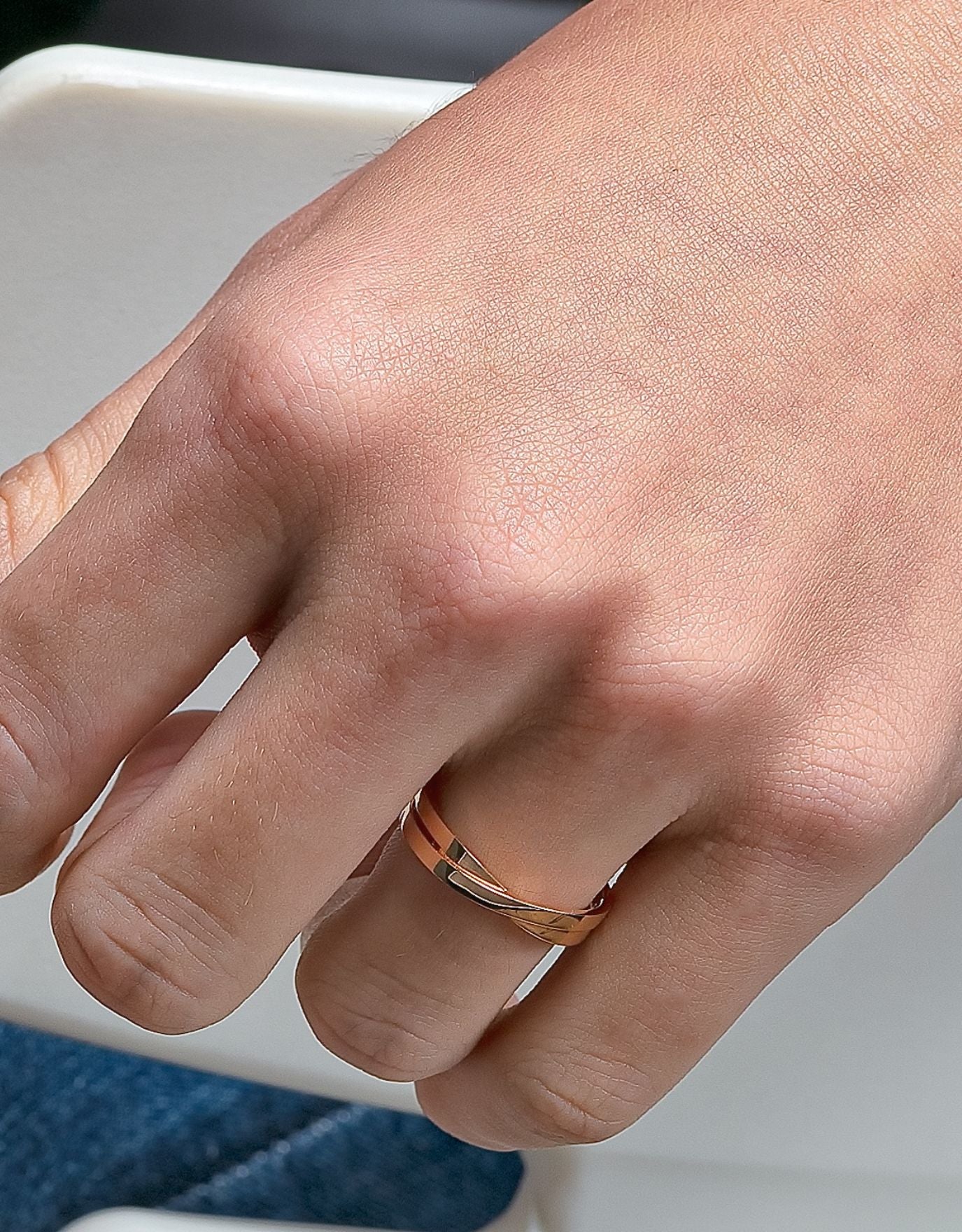 LVC couple wedding rings in white gold with glossy finish designed with a unique cross on the band for simplicity and elegance worn on ring finger 