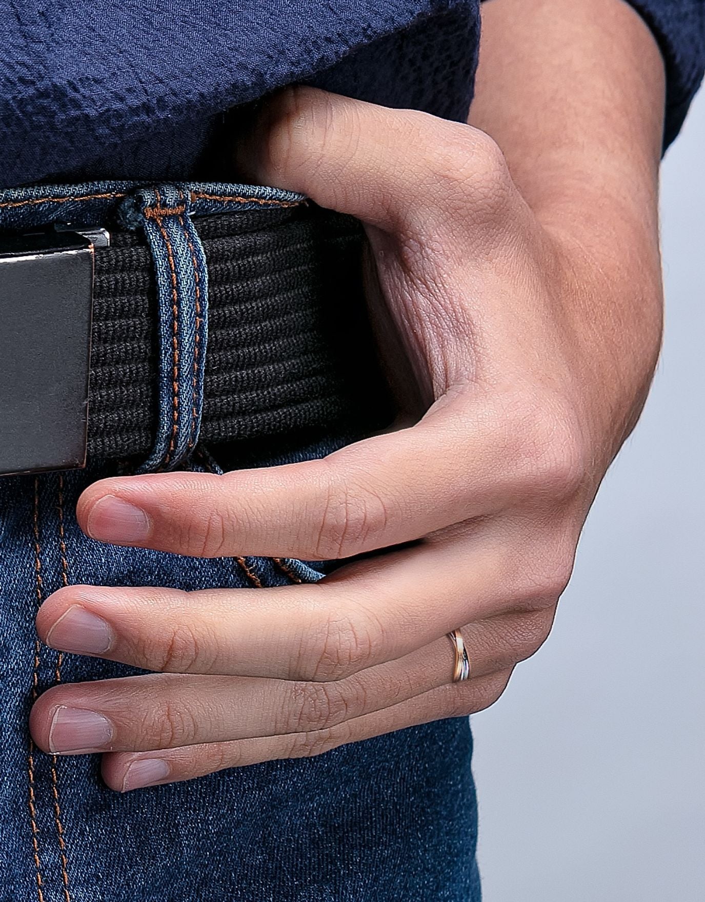 LVC wedding ring for men in white gold worn by a man on his ring finger with intertwining bands