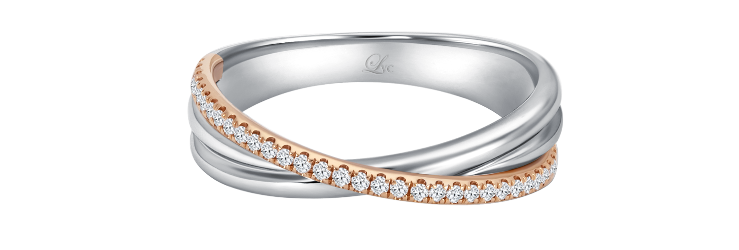 LVC wedding band in white and rose gold designed with an intertwining of bands fitted with a row of stunning diamonds that runs across the ring close up