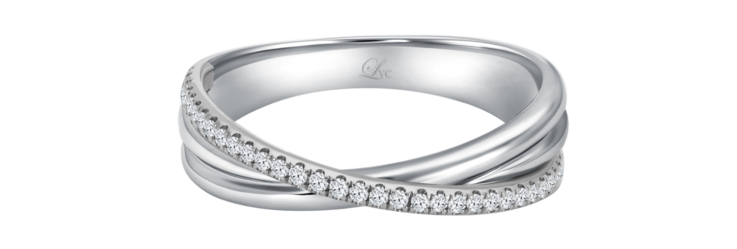 LVC wedding band in white gold designed with an intertwining of bands fitted with a row of stunning diamonds that runs across the ring close up