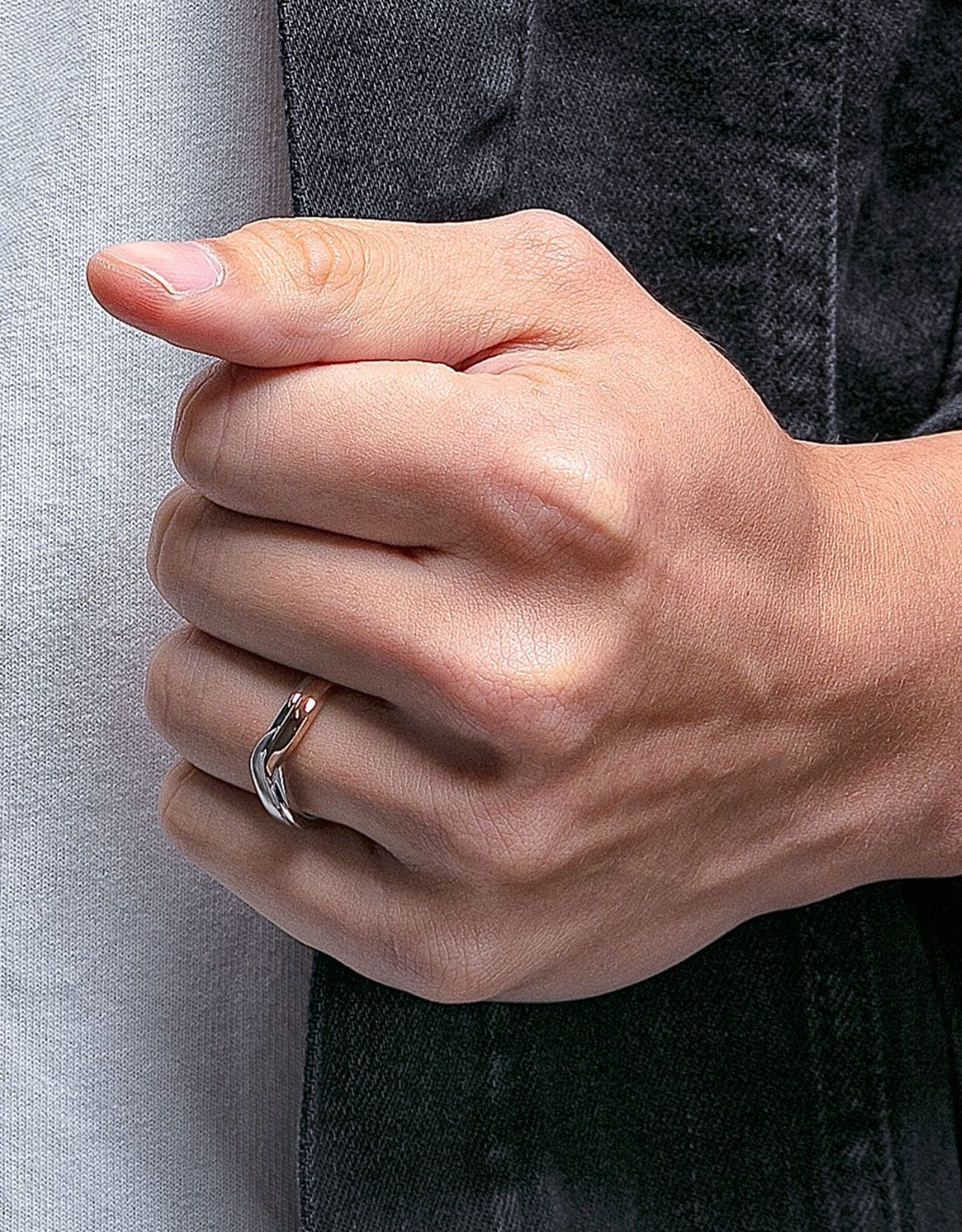 LVC mens diamond ring designed with a curved arc of overlapping lines of white and rose gold for a sophisticated and unique twist worn on ring finger