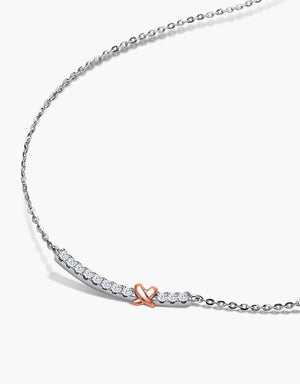 LVC Diamond Necklace in white gold designed with a dainty bow resting on a curved row of brilliant diamonds