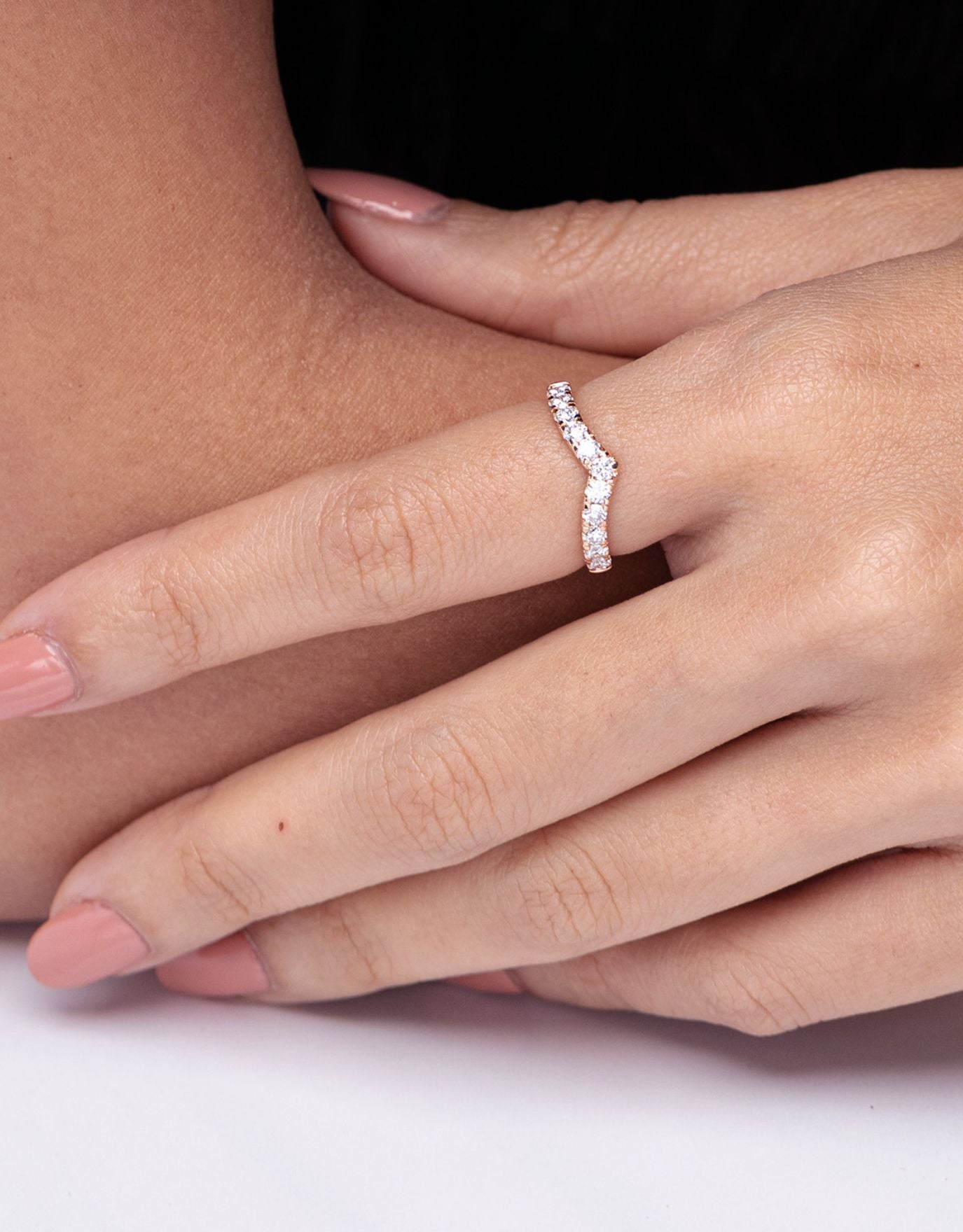 LVC wedding band in white gold crafted to be reminiscent of a classic V-line, and adorned with stunning diamonds worn by a woman