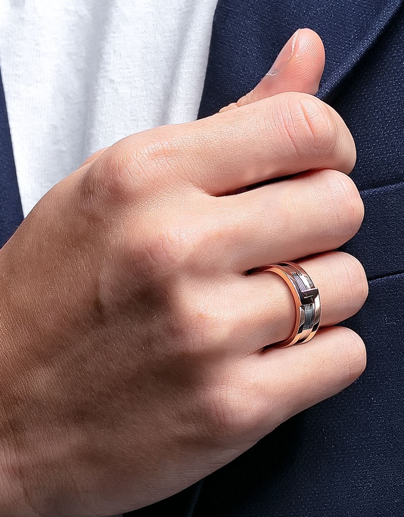 LVC man wearing a wedding ring for men with rose gold on the outer layer of the ring