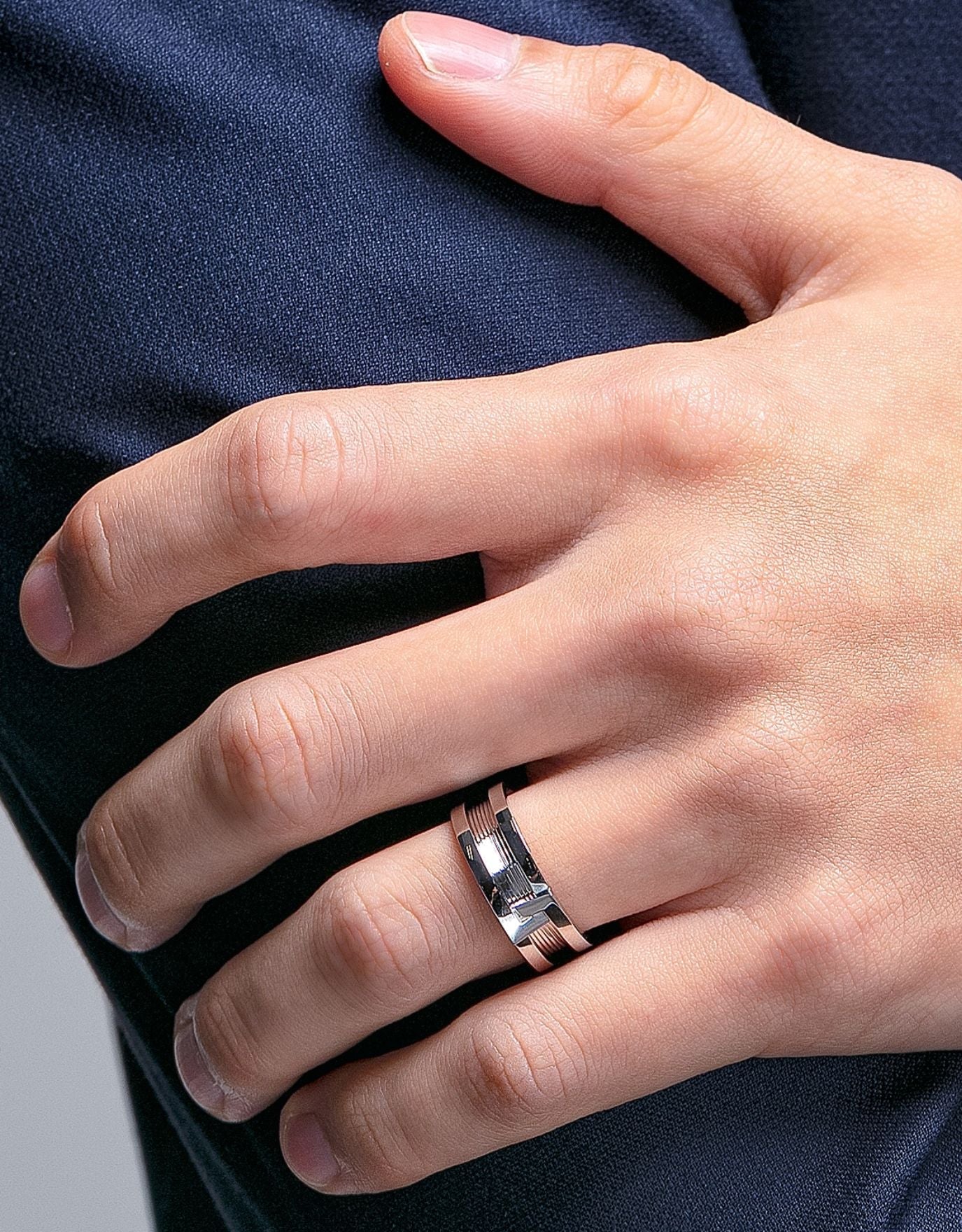LVC man wearing a wedding ring for men that is inspired by a bolt and a nut