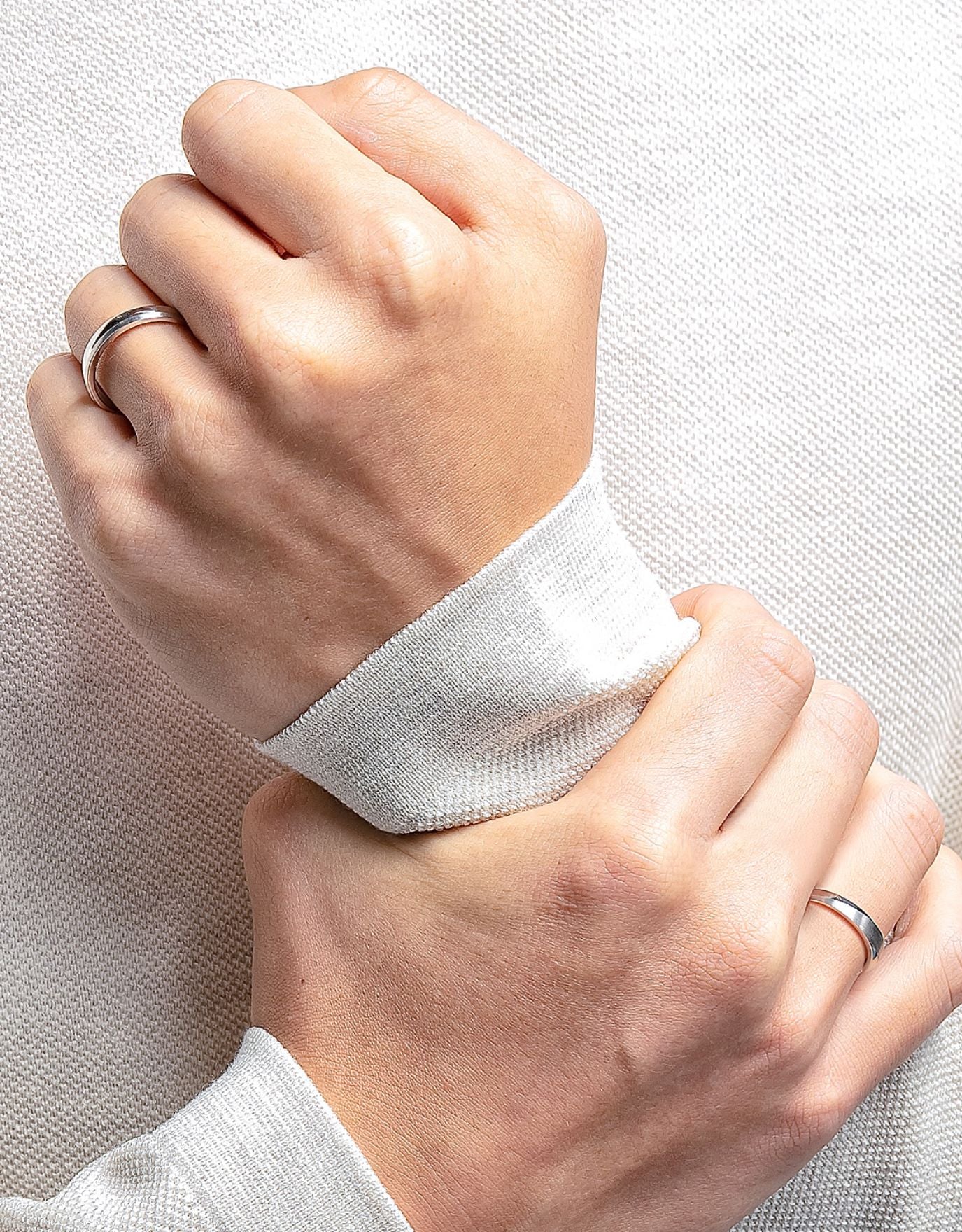 LVC men wedding ring in platinum worn on the left hand with another ring on the right hand