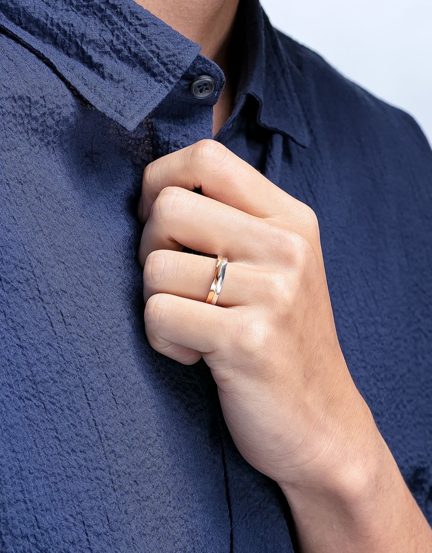 LVC men wedding ring with subtle curves of white gold and rose gold worn by a man on his ring finger