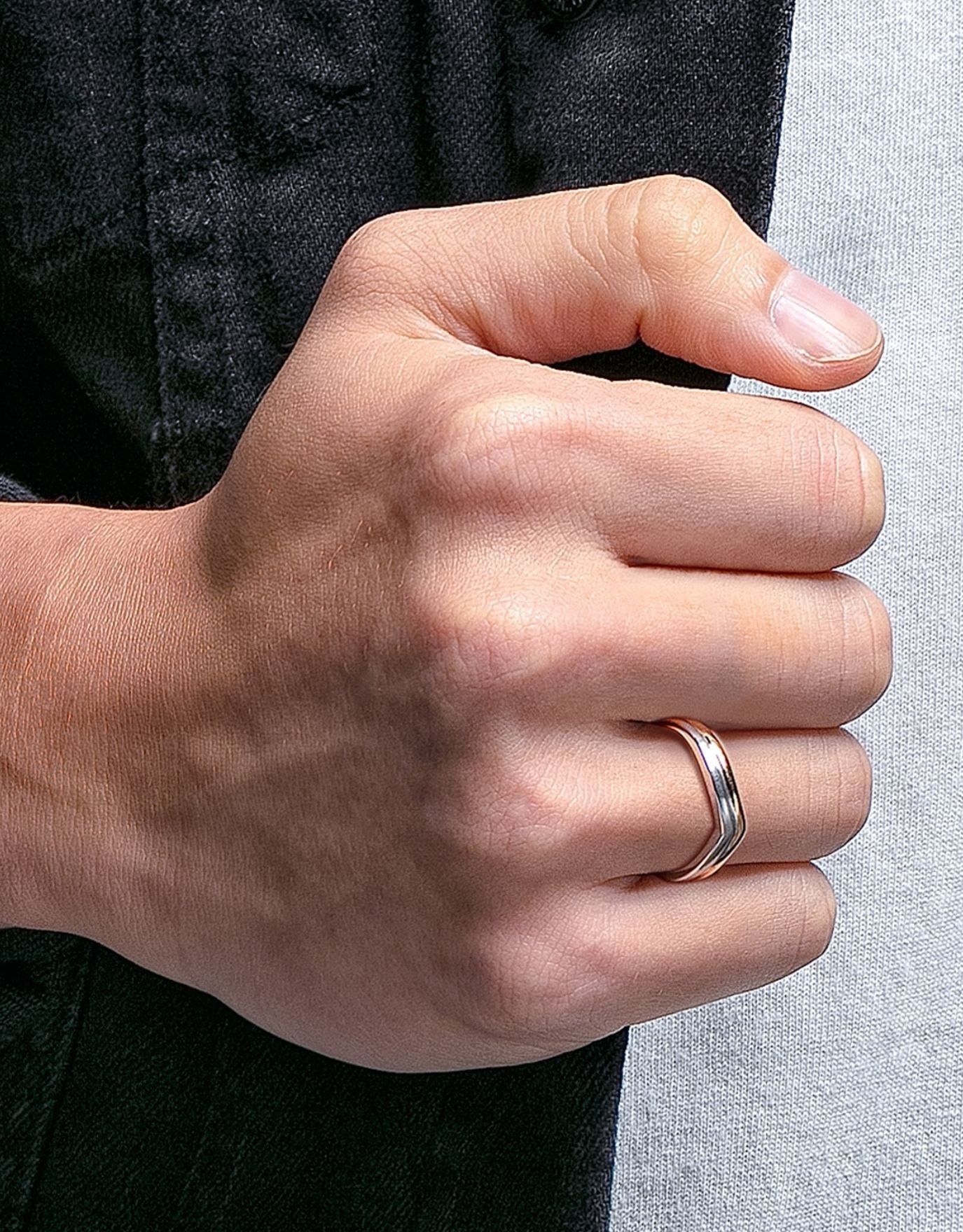 LVC men wedding band designed with a curved arc in white and rose gold for an elegant and modern look worn on ring finger