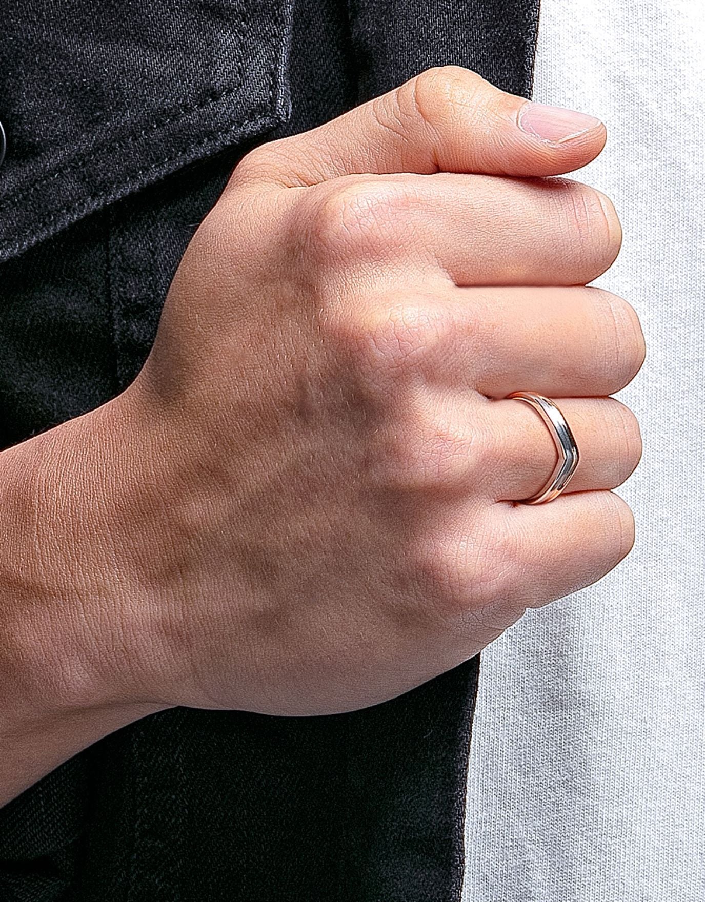 LVC men wedding band designed with a curved arc in white and rose gold for an elegant and modern look worn on ring finger 