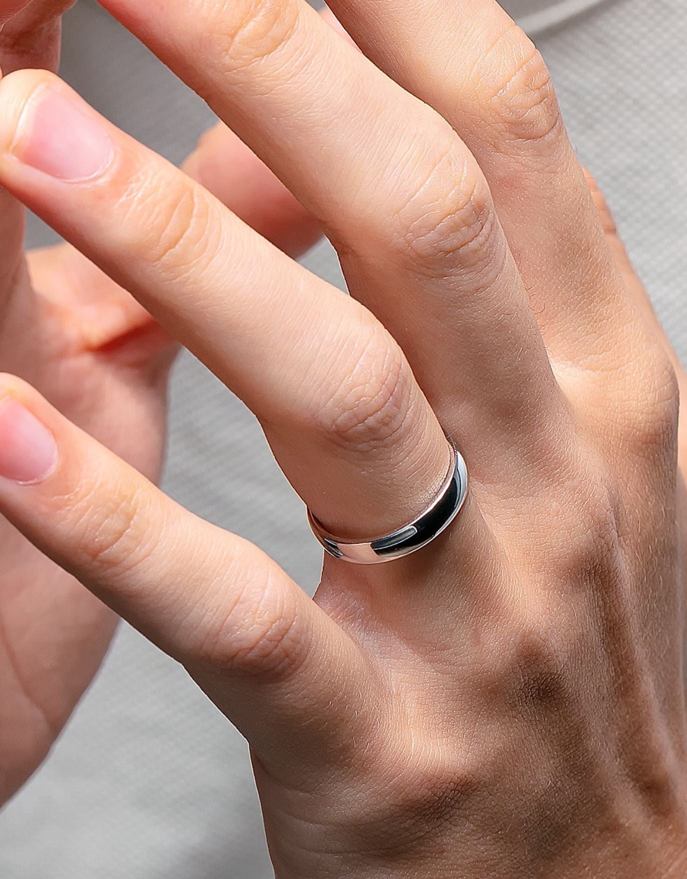 LVC men wedding band in platinum crafted with a glossy finish for the elegant and modern look worn on ring finger