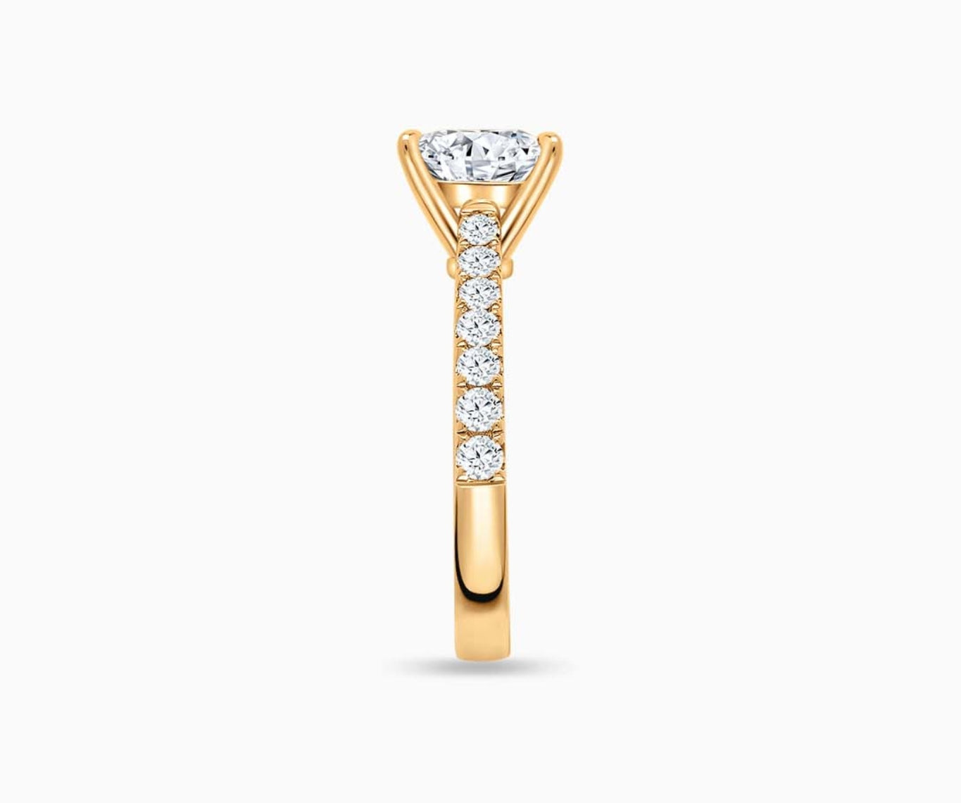 LVC solitaire ring with classic straight pave band lined with side diamonds and big diamond on the centre in yellow gold from side view