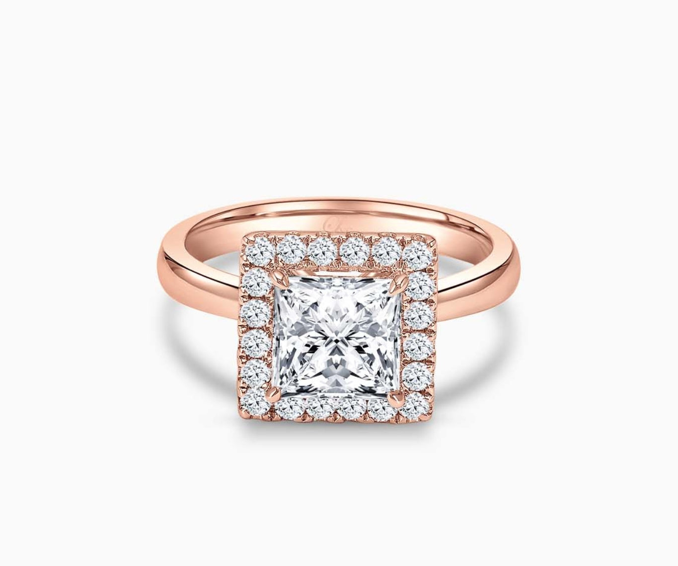 princess cut diamond halo engagement ring set in rose gold with a tapered plain band design