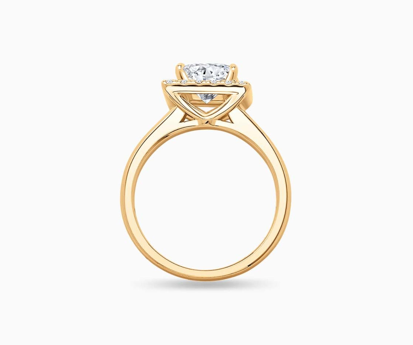 side view of princess cut diamond halo engagement ring set on yellow gold with a tapered plain band design