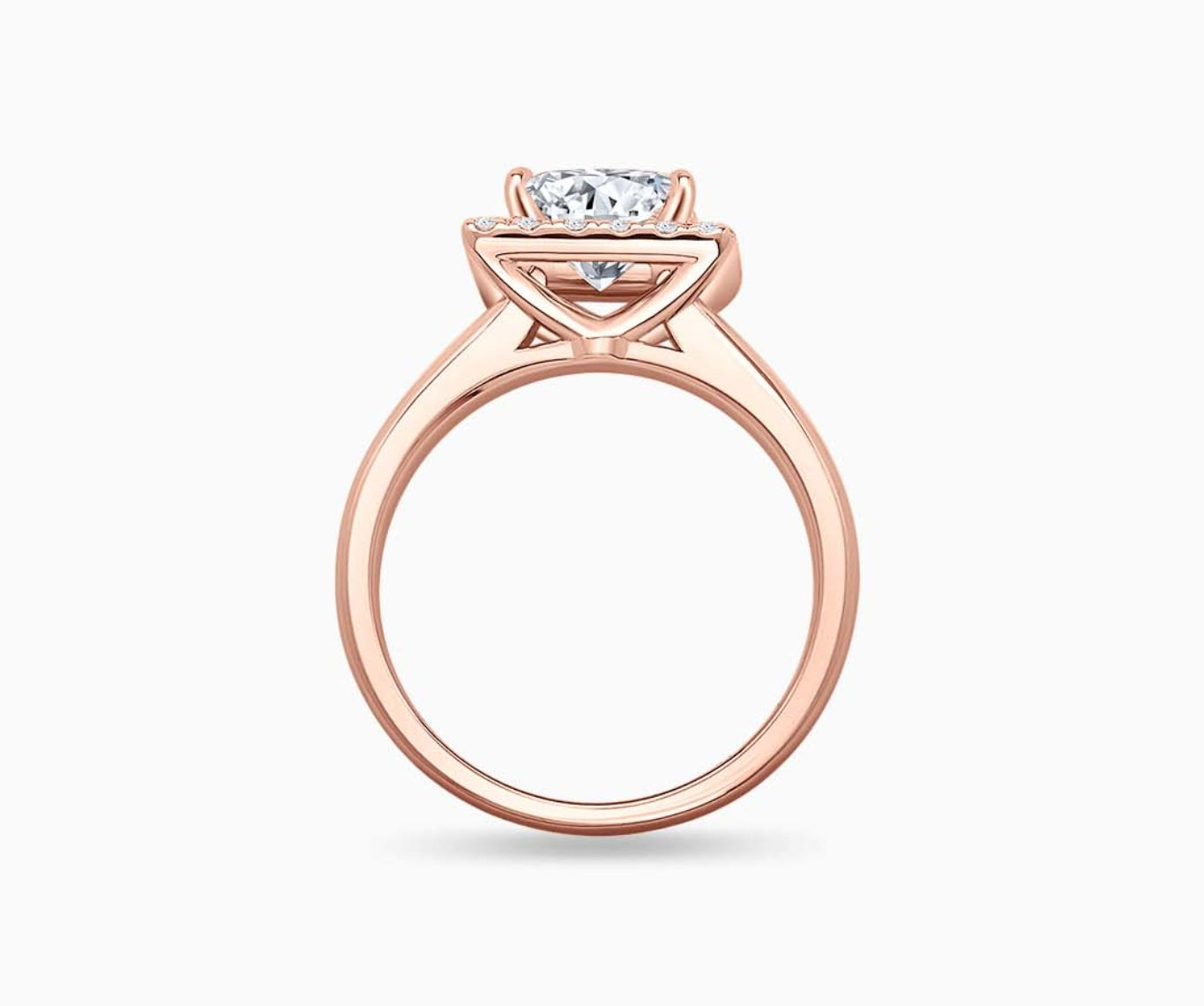 side view of princess cut diamond halo engagement ring set in rose gold with a straight plain band design
