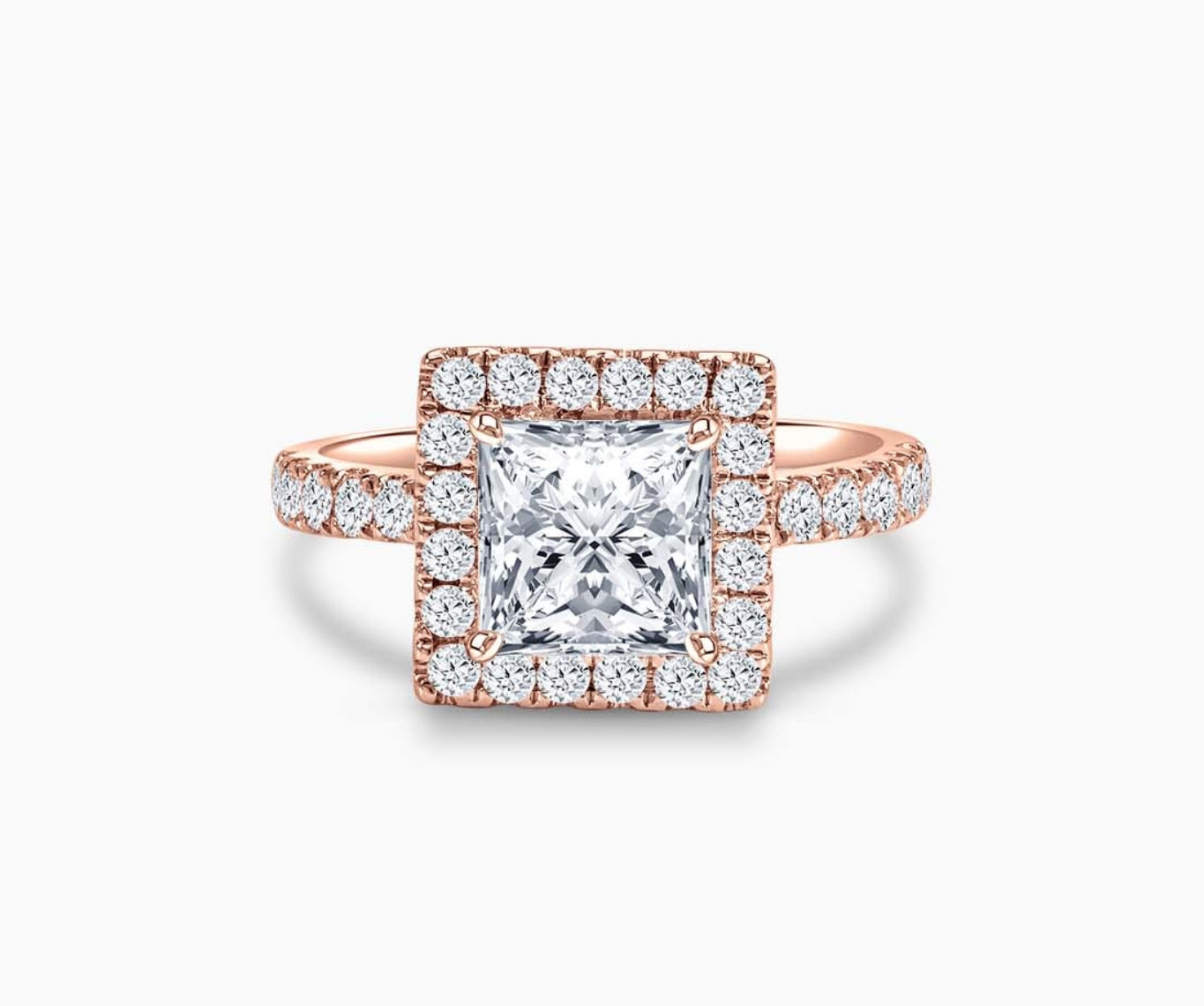 princess cut diamond halo engagement ring set in rose gold with a tapered pave band design