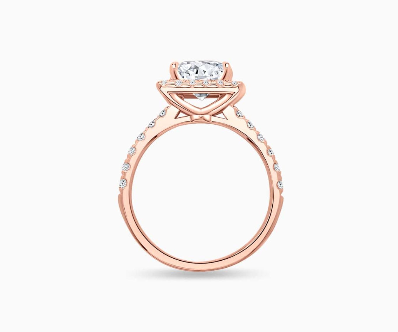 side view of princess cut diamond halo engagement ring set in rose gold with a tapered pave band design