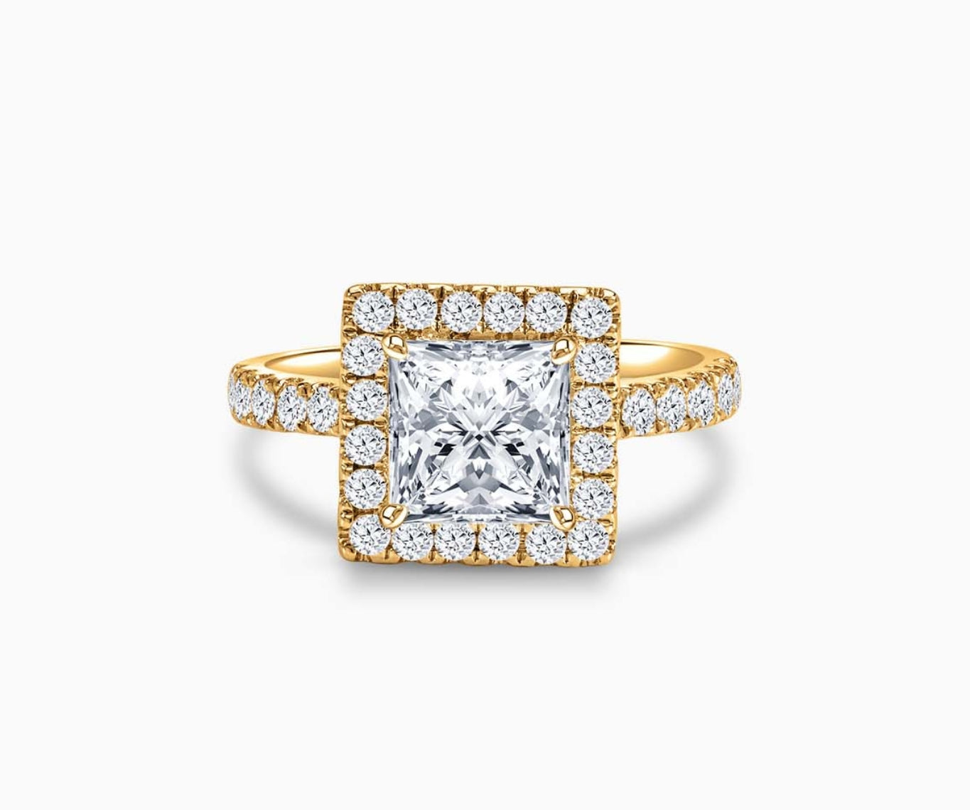 Princess cut diamond halo engagement ring set on yellow gold with a tapered pave band design