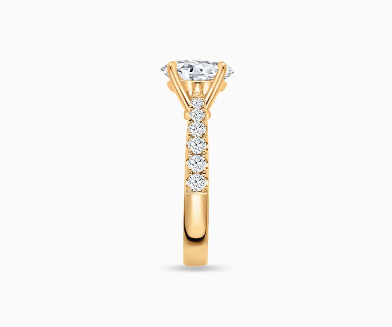 LVC solitaire rings with tapered pave band with centre diamond, and lined with side diamonds in yellow gold from side view