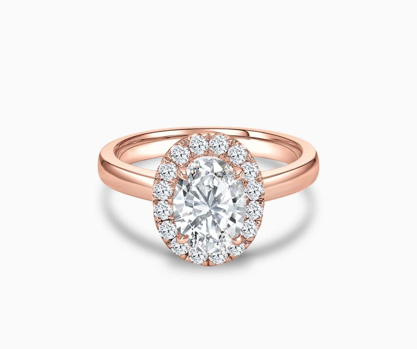 An oval-cut diamond halo engagement ring set on rose gold with a straight plain band design