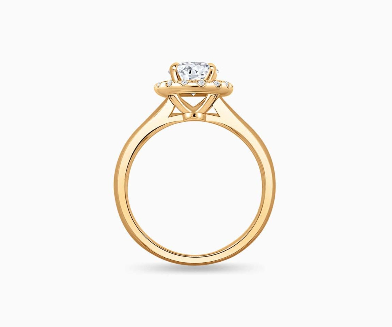 side view of Oval cut diamond halo engagement ring set on yellow gold with a straight plain band design