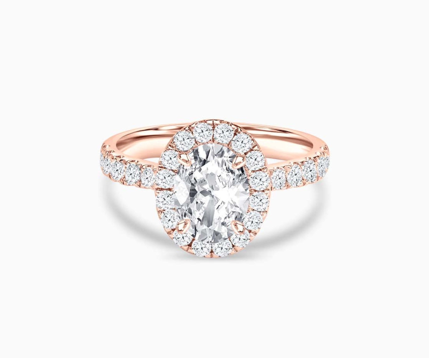 An oval-cut diamond halo engagement ring set on rose gold with a tapered pave band design