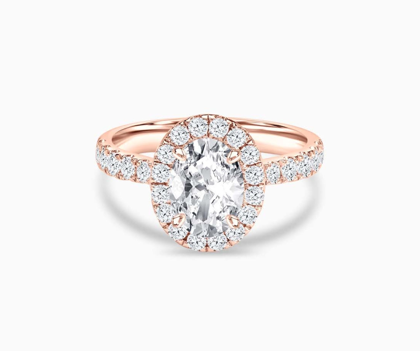 An oval-cut diamond halo engagement ring set on rose gold with a tapered pave band design