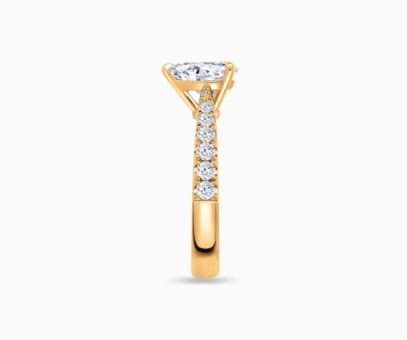 LVC solitaire rings with tapered pave band with centre diamond, and lined with side diamonds in yellow gold from side view