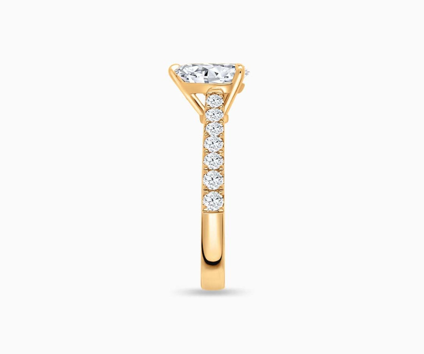 LVC solitaire ring with classic straight band lined with side diamonds and a diamond on the centre in yellow gold from side view