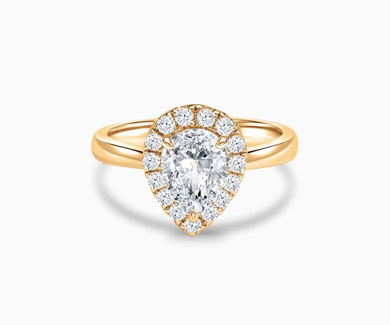 Pear Shaped diamond halo engagement ring set on yellow gold with a tapered plain band design