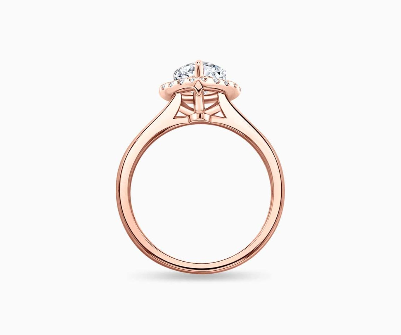side view of pear shaped diamond halo engagement ring set in rose gold with a straight plain band design