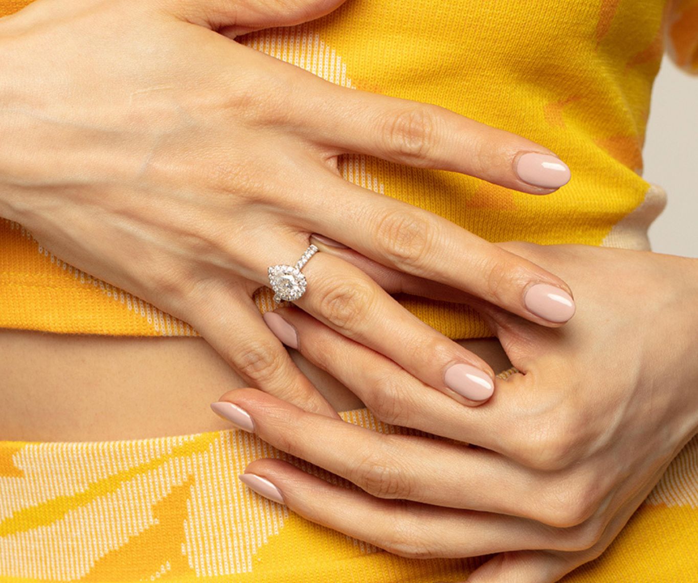 women wearing Pear Shaped halo diamond engagement ring with straight pave band