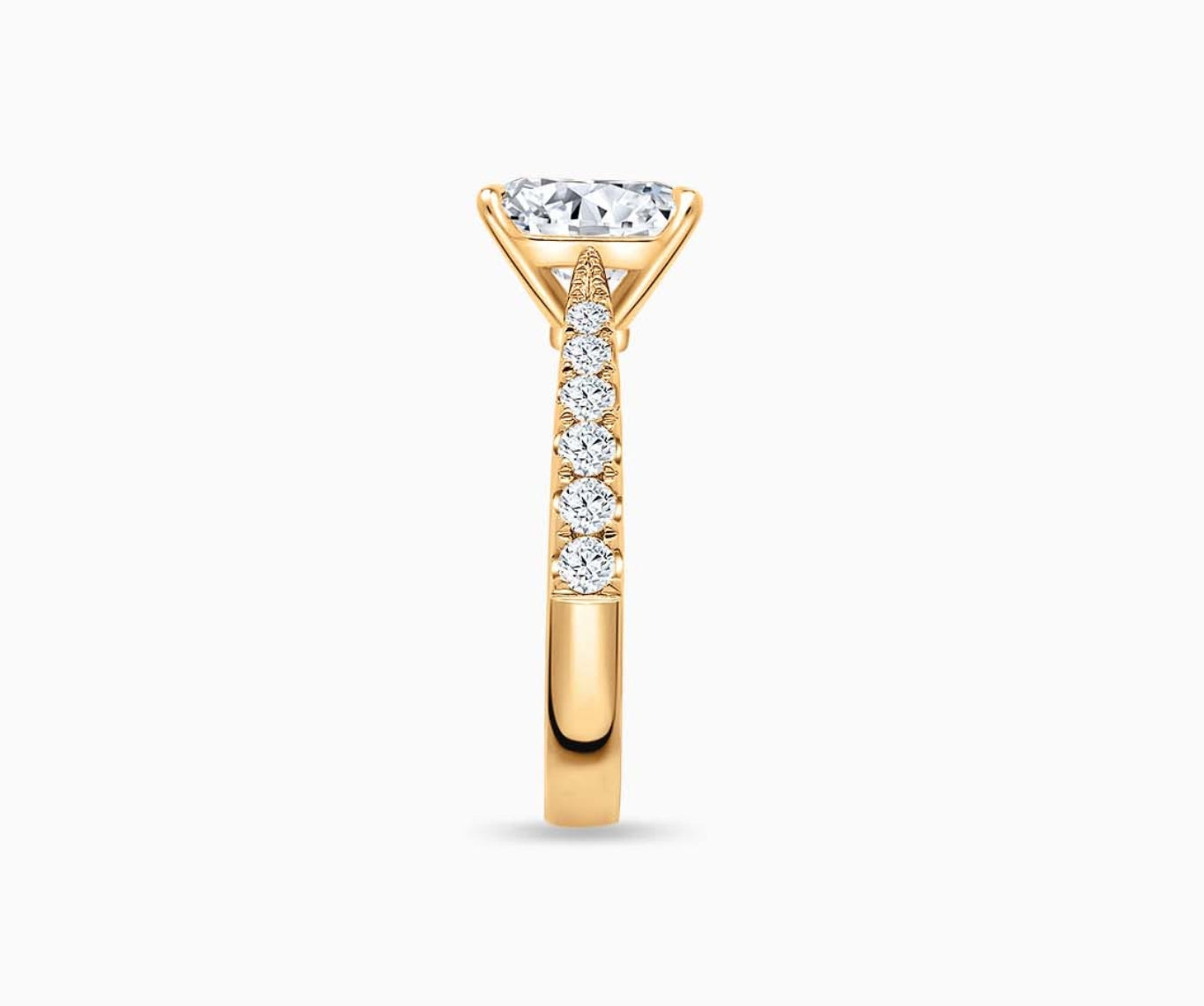 LVC solitaire rings with tapered pave band with centre diamond, and lined with side diamonds in yellow gold from side view