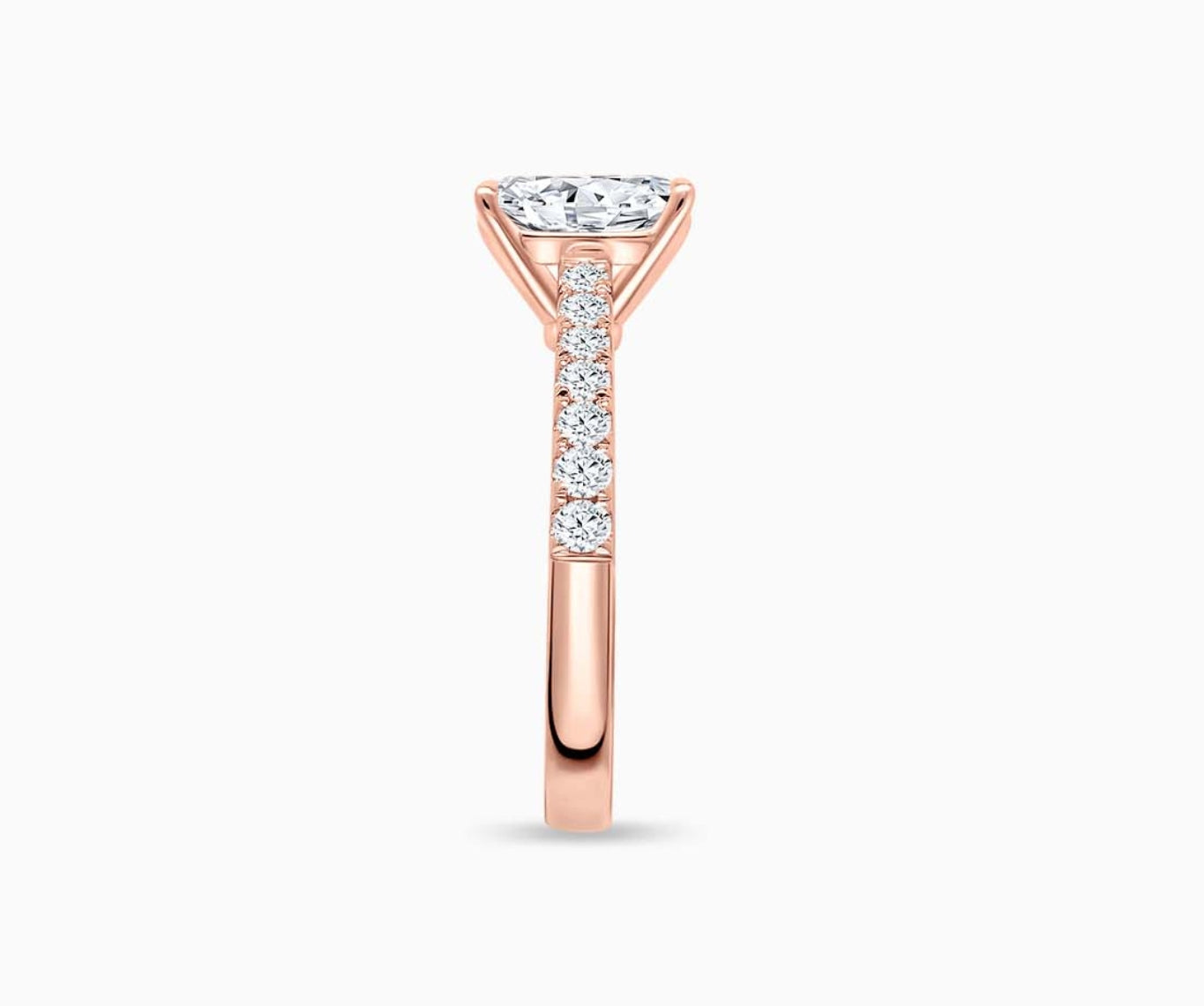 LVC solitaire ring with classic straight pave band lined with side diamonds in rose gold from side angle