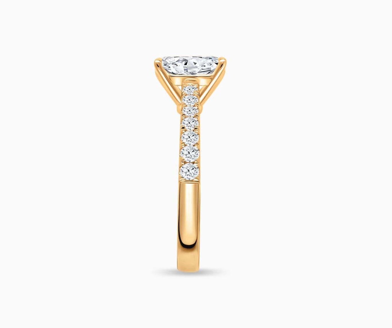 LVC solitaire ring with classic straight band lined with side diamonds and a diamond on the centre in yellow gold from side view