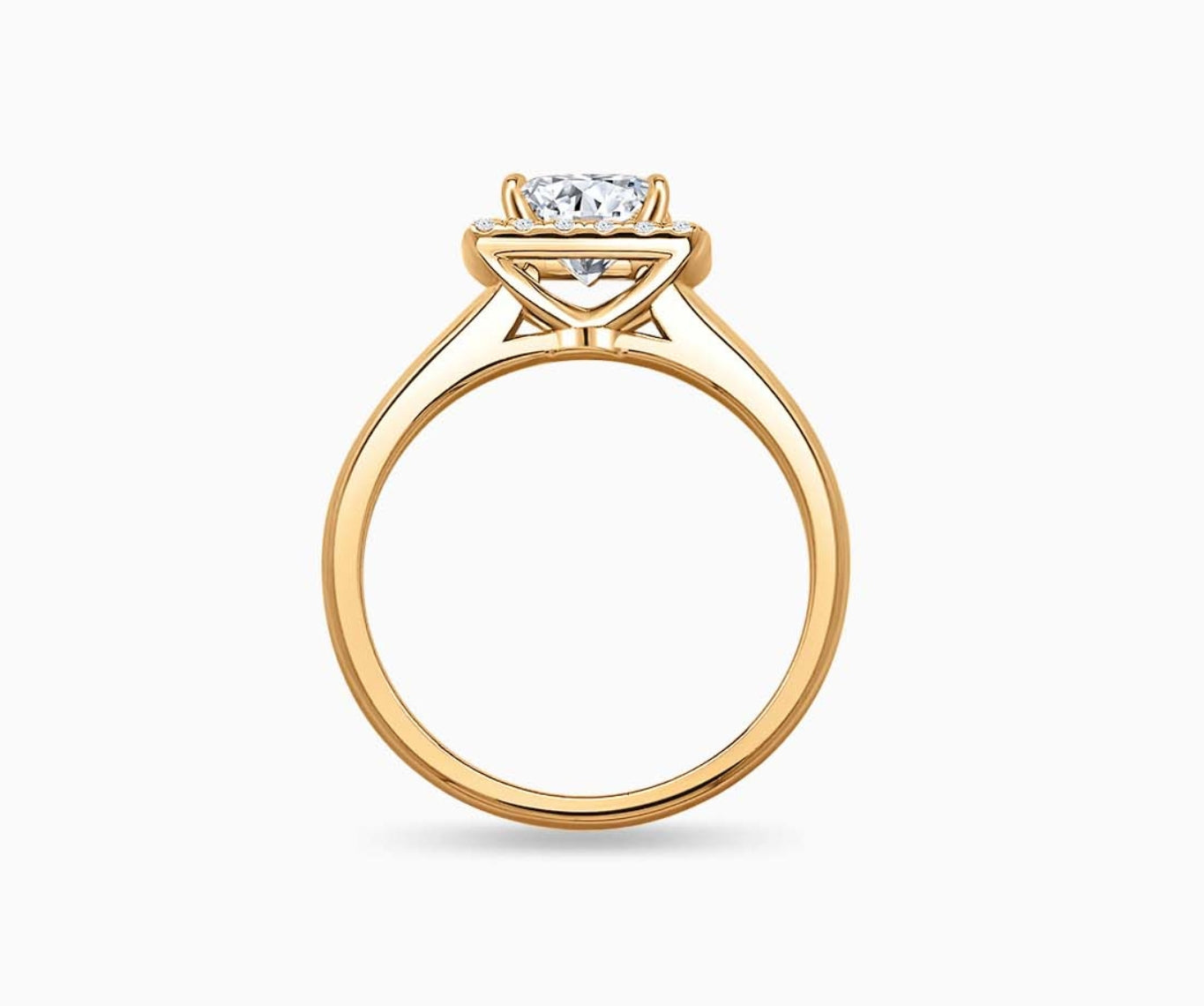 side view of Emerald cut diamond halo engagement ring set on yellow gold with a straight plain band design