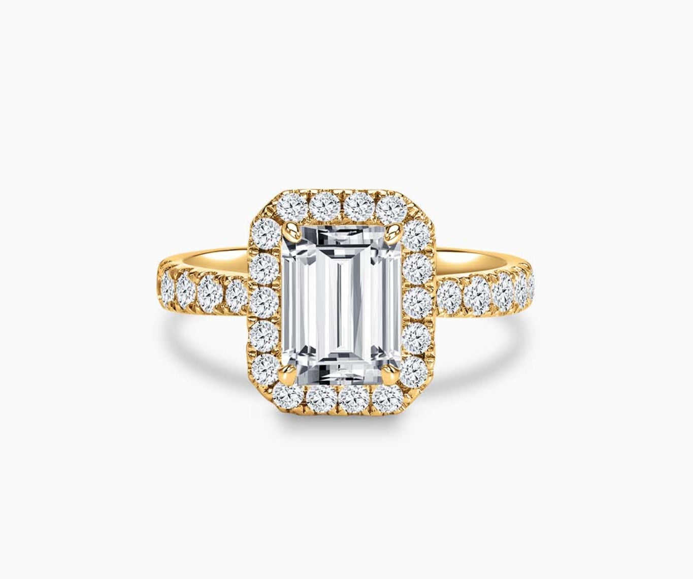 Emerald cut diamond halo engagement ring set on yellow gold with a tapered pave band design
