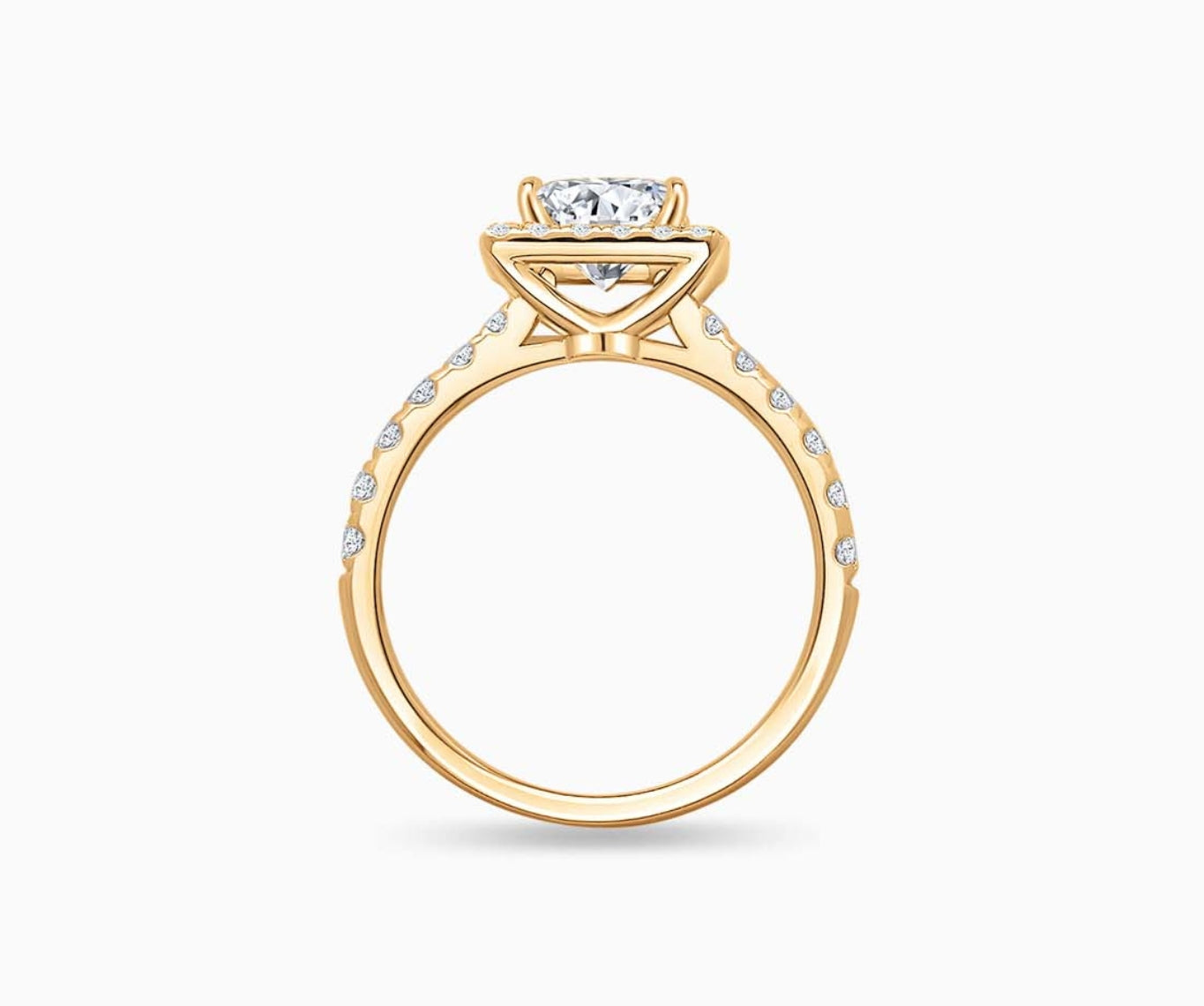 side view of Emerald cut diamond halo engagement ring set on yellow gold with a tapered pave band design