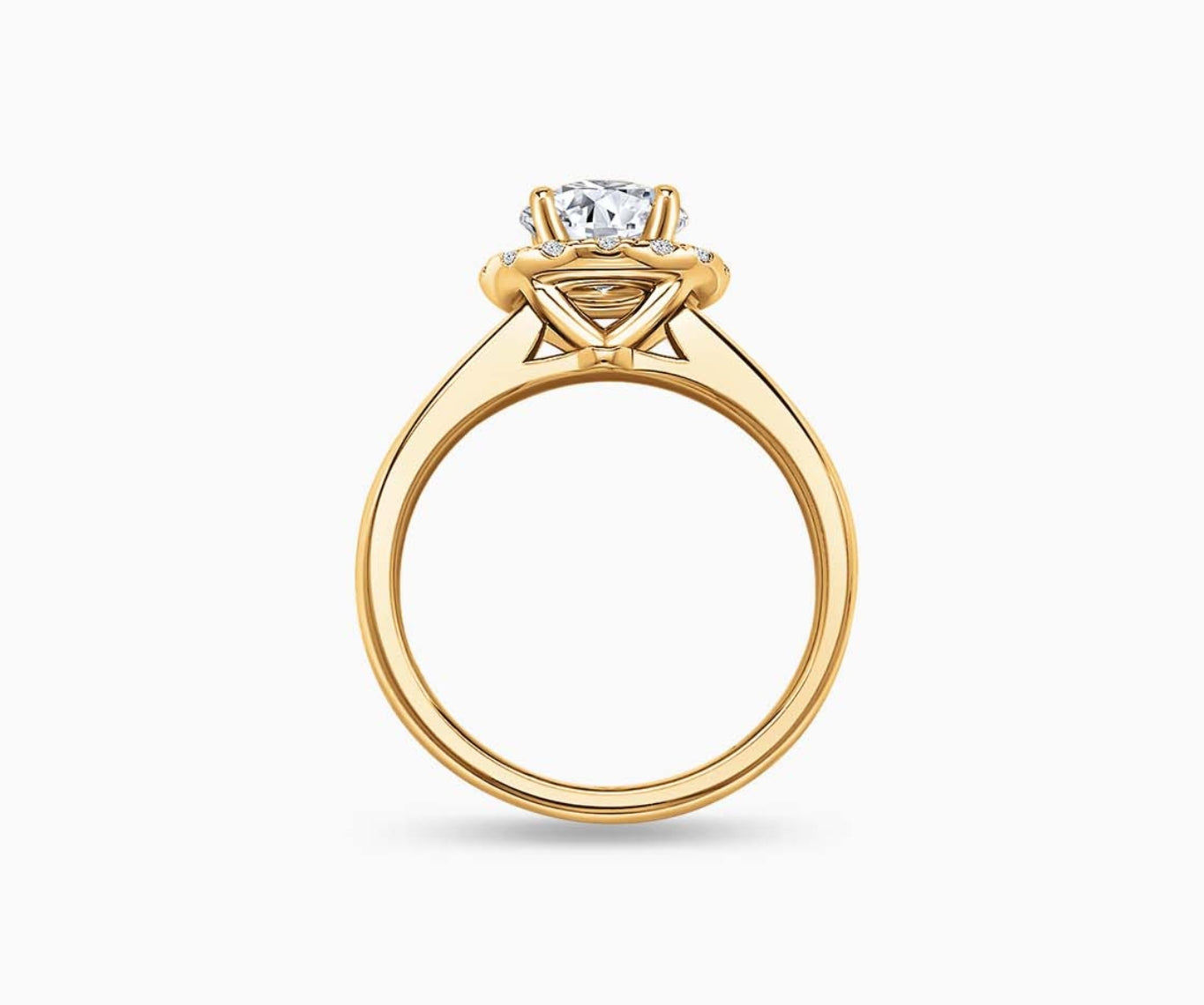 side view of Round cut diamond halo engagement ring set on yellow gold with a straight plain band design
