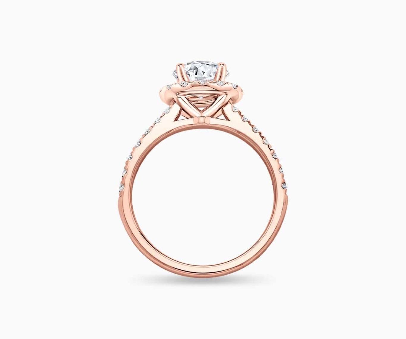 side view of round diamond halo engagement ring set in rose gold with a straight pave band design