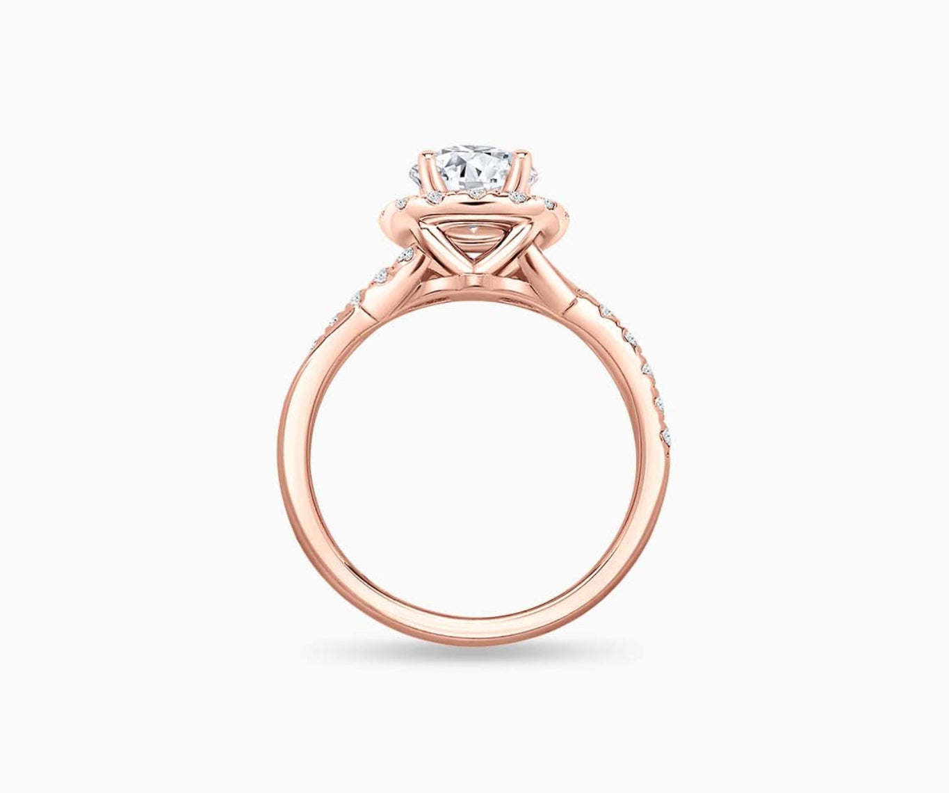 side view of round diamond halo engagement ring set in rose gold with a twisted pave band design