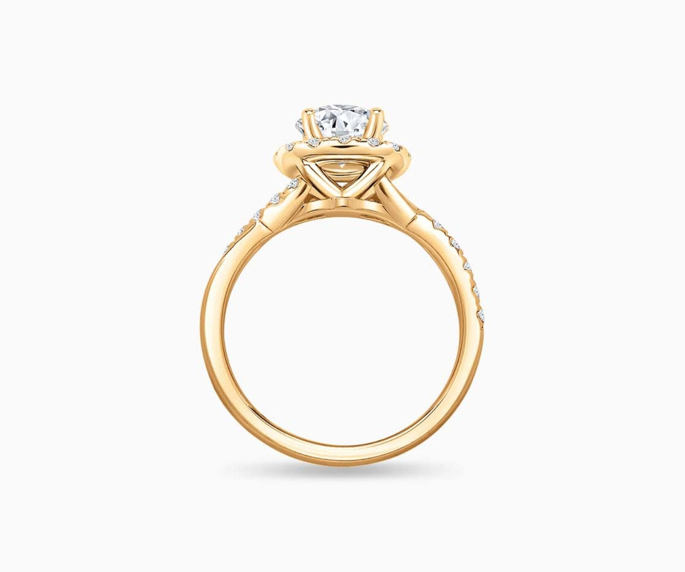 side view of Round cut diamond halo engagement ring set on yellow gold with a twisted pave band design