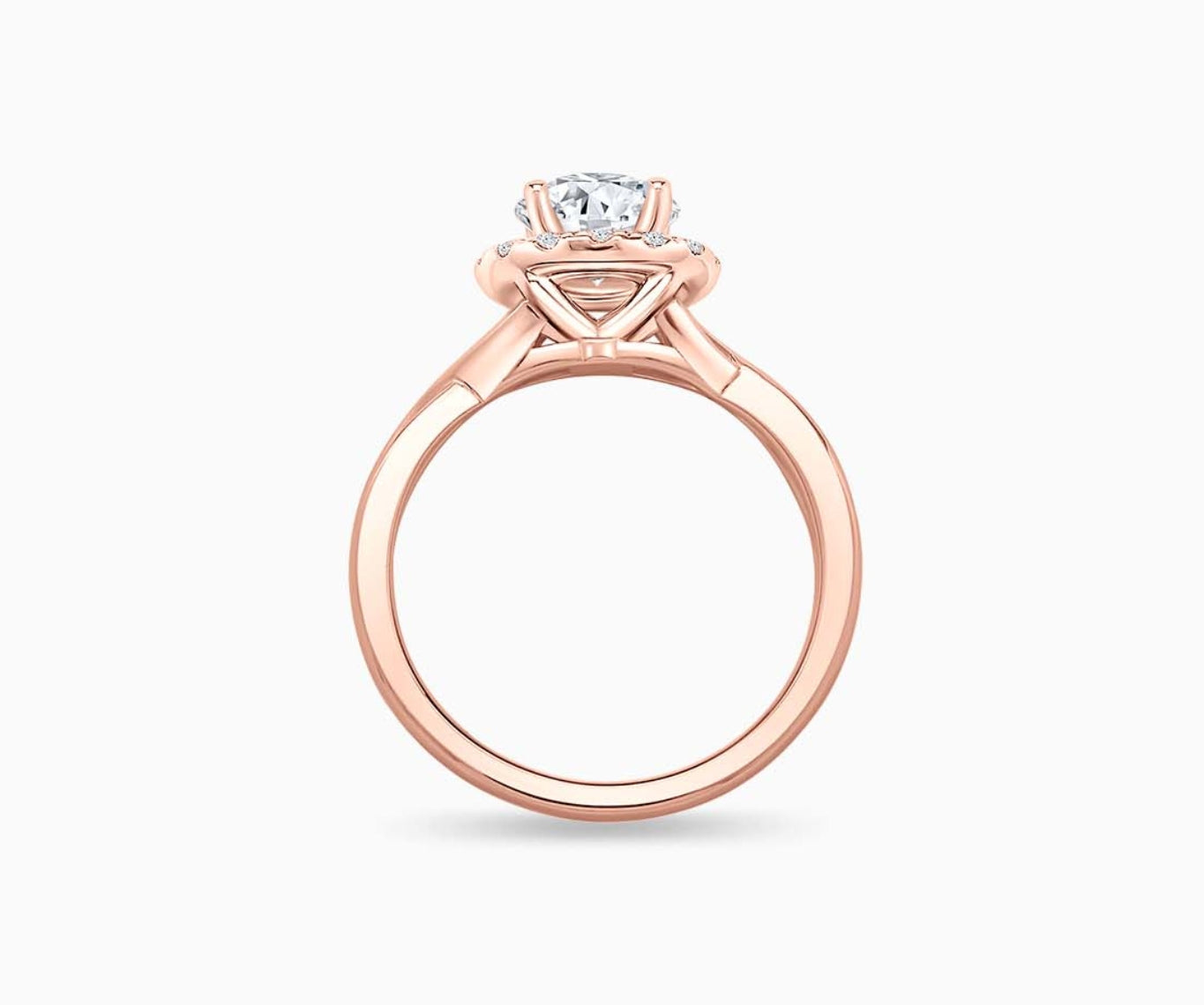 side view of round diamond halo engagement ring set in rose gold with a twisted plain band design